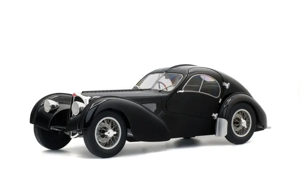 Black streamlined classic Bugatti coupe on a studio background